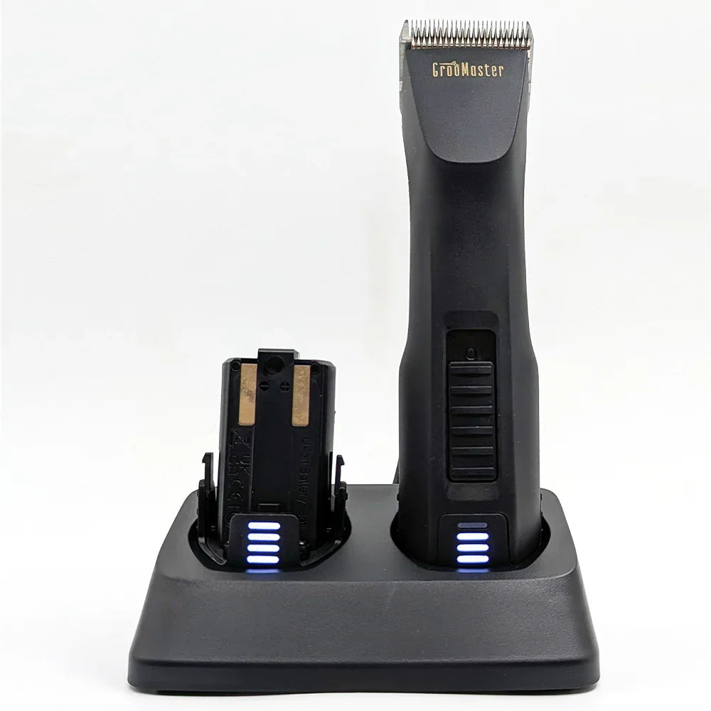 Groomaster Max1 clipper with additional battery both being charged on the charging dock