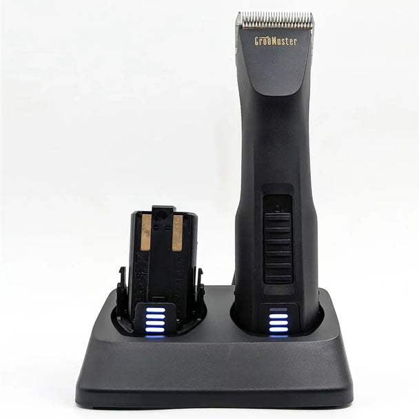 Groomaster Max1 clipper with additional battery both being charged on the charging dock