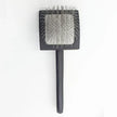 sleeker brush with stainless steel bristles on a white background