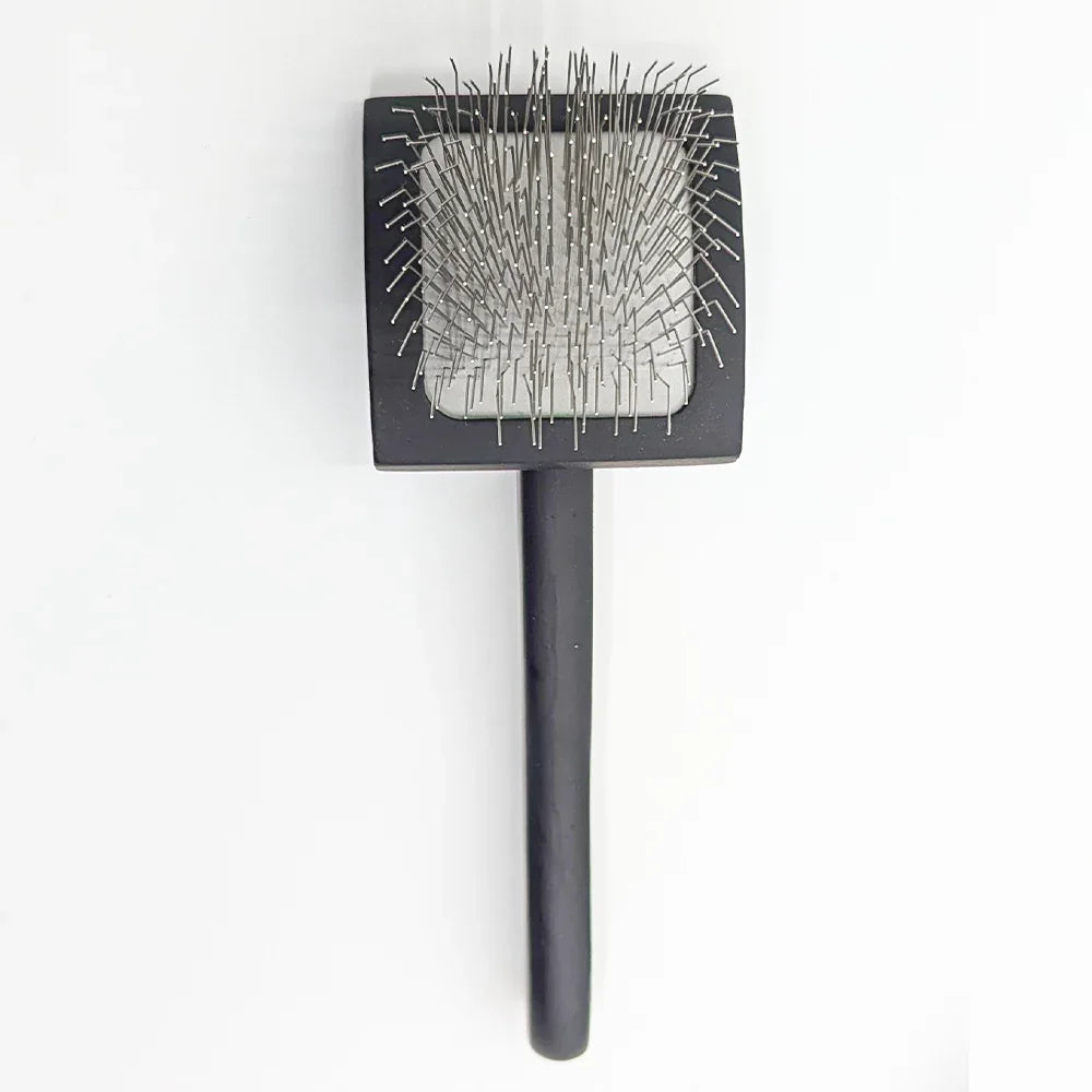 sleeker brush with stainless steel bristles on a white background