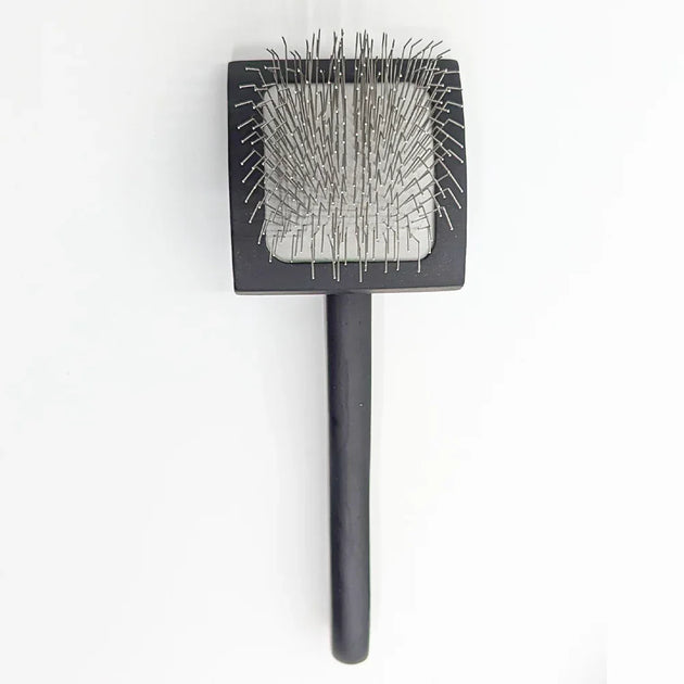 sleeker brush with stainless steel bristles on a white background