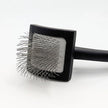 Square black brush with bristles on a white background