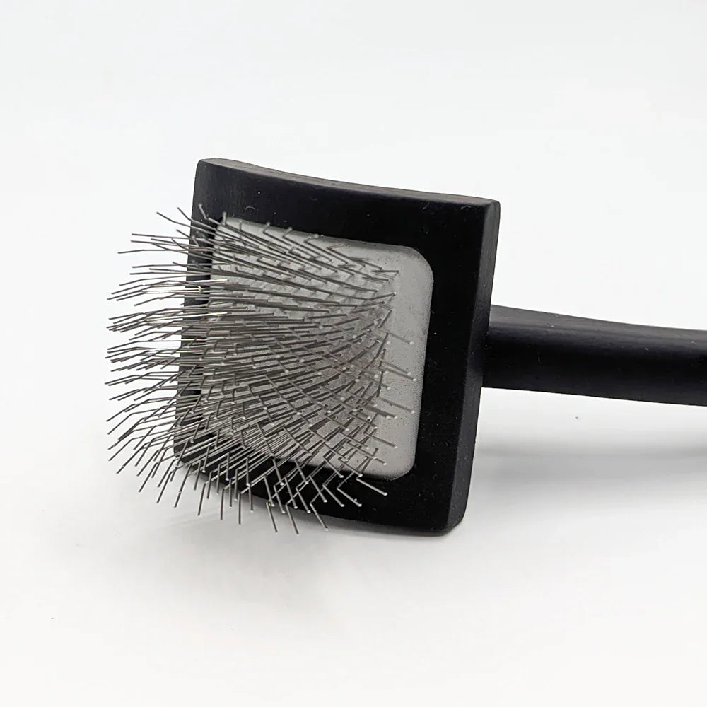 Square black brush with bristles on a white background