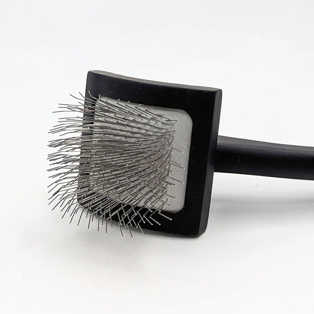 Square black brush with bristles on a white background