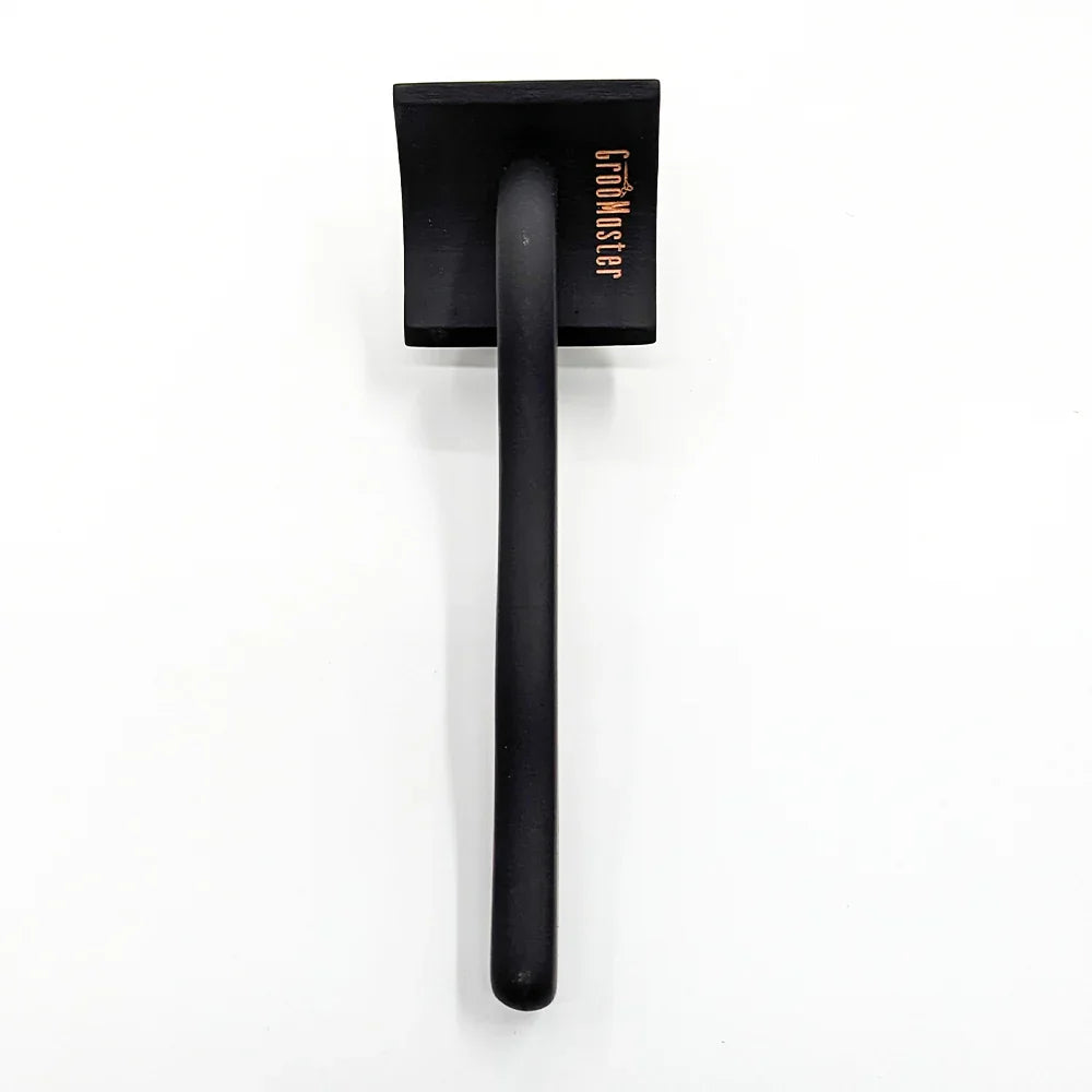 Black sleeker backside handle with square black head with brand "groomaster" written, kept on a white background