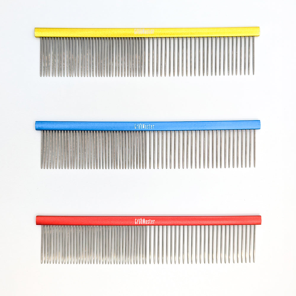 Three combs with different colored handles on a white background
