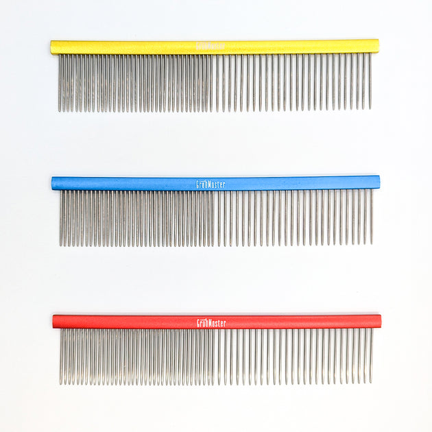 Three combs with different colored handles on a white background
