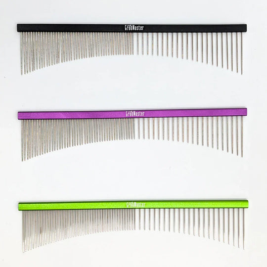 Three combs with different color handles on a white background