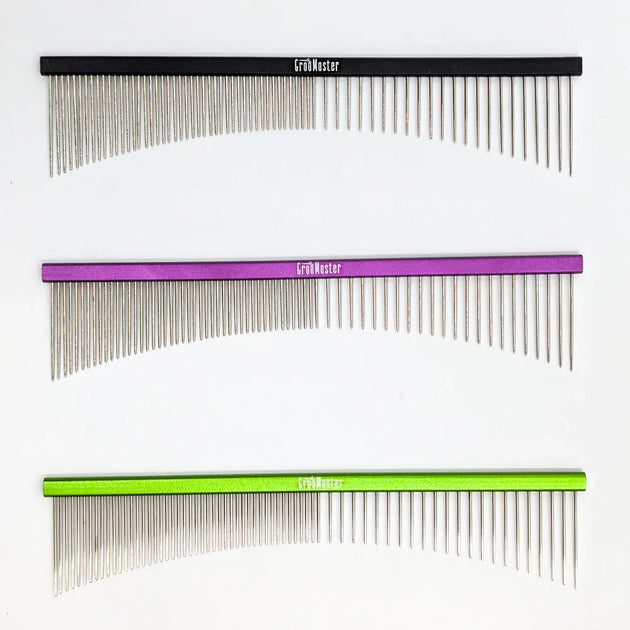 Three combs with different color handles on a white background