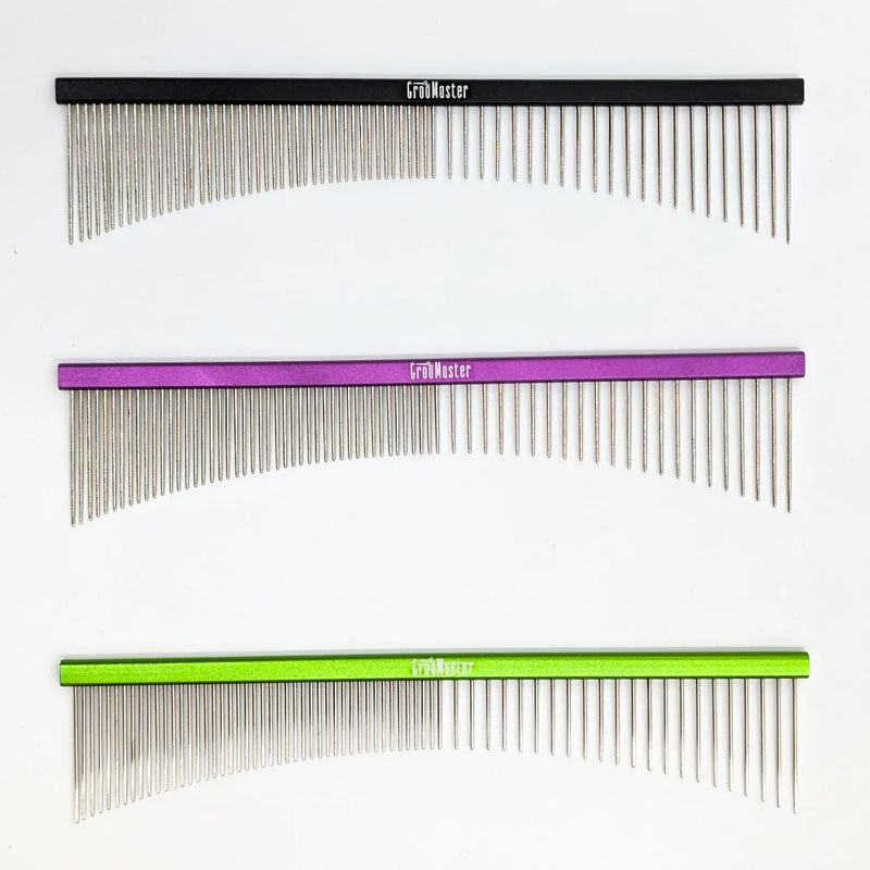 Three combs with different color handles on a white background