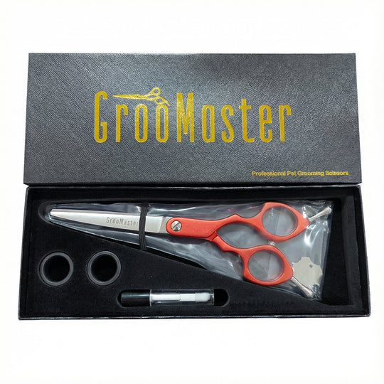 Groomaster professional pet grooming shears set in a black box with gold text.